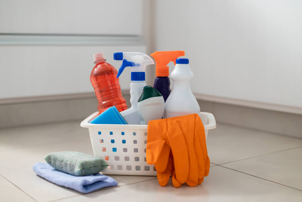 some cleaning supplies gathered in a white basket